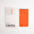 Venta Portable Silicone Holder in Orange beside its box