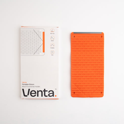 Venta Portable Silicone Holder in Orange beside its box